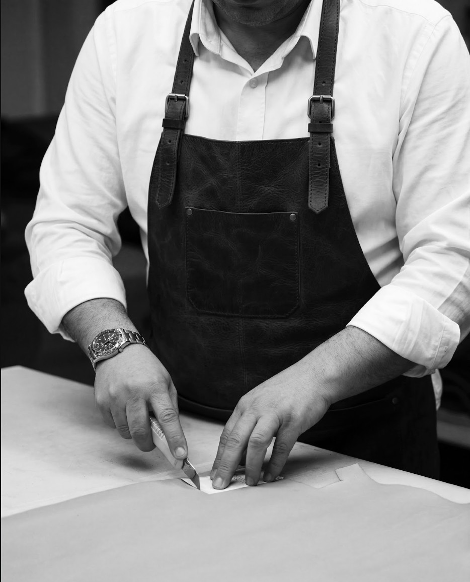 A pattern being cut by hand